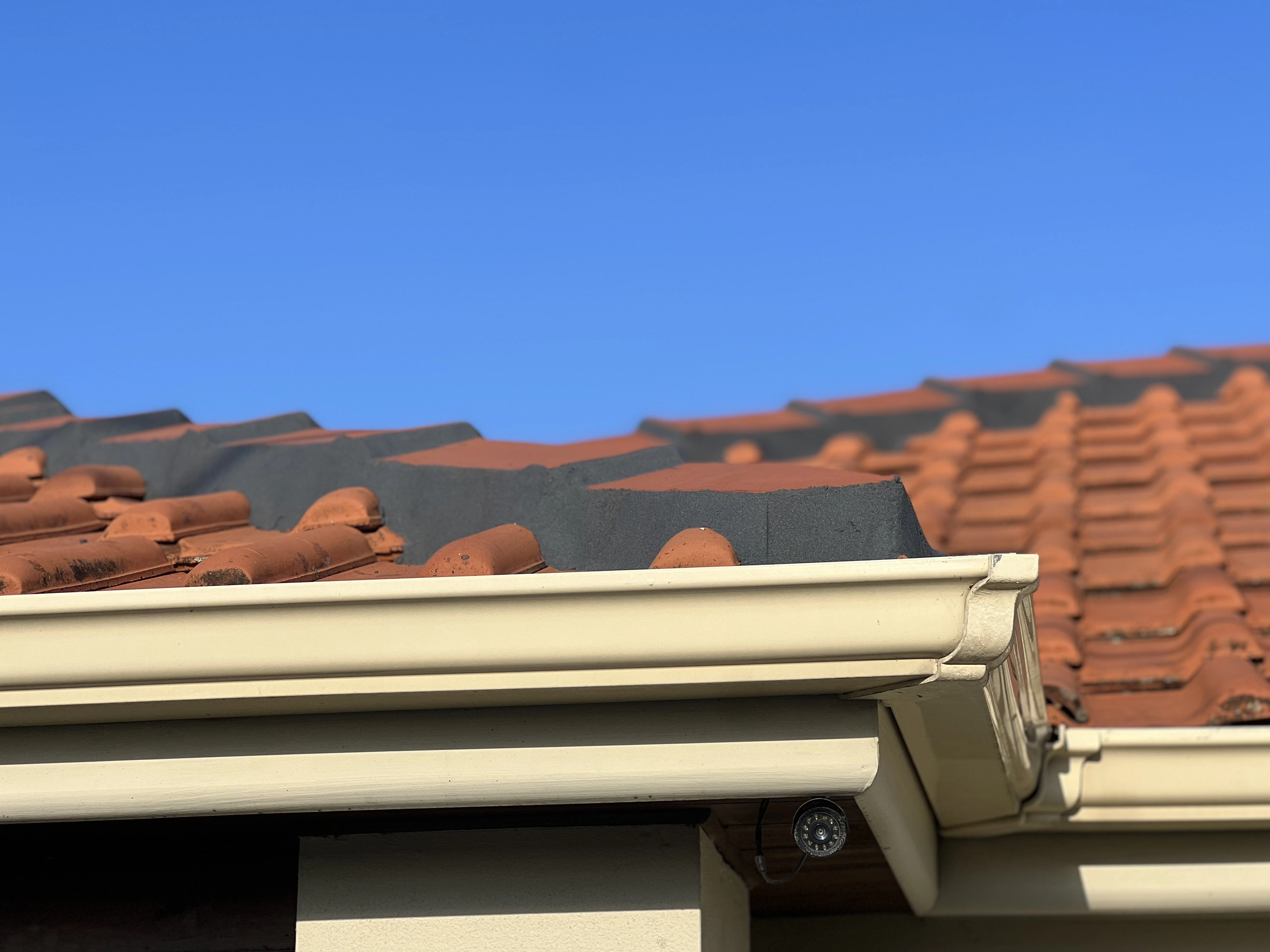 Residential roof after complete painting and maintenance service