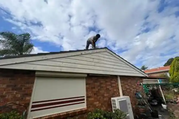Skilled roof painters working on a home in South West Sydney, providing dependable roof maintenance services